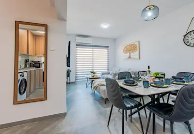 a dining room and living room with a table and chairs at TelMar Sky View in Larnaka