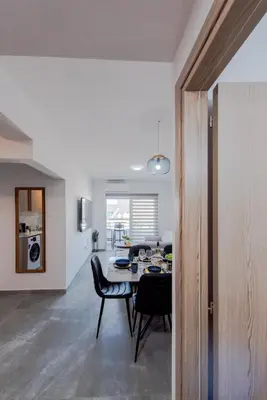 a dining room and kitchen with a table and chairs at TelMar Sky View in Larnaka