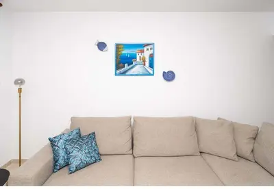 a couch in a living room with a picture on the wall at Stella's Little Island Gem in Paralimni