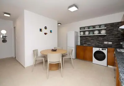 a kitchen with a table and chairs in a room at Stella's Little Island Gem in Paralimni