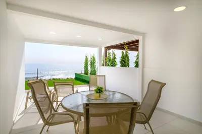 a dining room with a table and chairs at Wavestone Beachfront House in Meneou