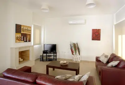 a living room with a couch and a table at Villa Elise in Protaras