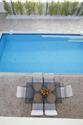 an overhead view of a table and chairs next to a swimming pool at Villa Elise in Protaras