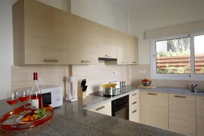a kitchen with a plate of fruit and wine glasses at Villa Elise in Protaras