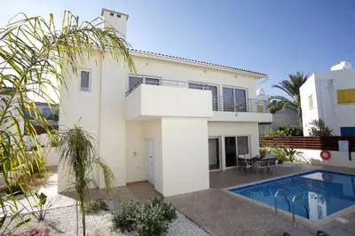 a house with a swimming pool in front of it at Villa Elise in Protaras