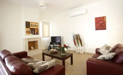a living room with a couch and a table at Villa Elise in Protaras