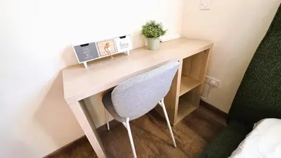 a wooden desk in a room with a chair at Sunny 2BR Getaway Steps from the Beach with Wi-Fi in Larnaka