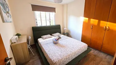 a bedroom with a bed with a phone on it at Sunny 2BR Getaway Steps from the Beach with Wi-Fi in Larnaka