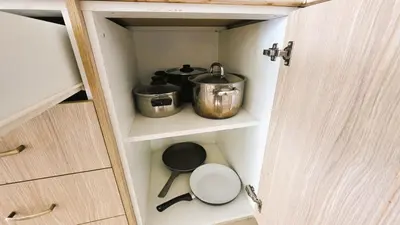 a cupboard with two pots and pans in it at Sunny 2BR Getaway Steps from the Beach with Wi-Fi in Larnaka