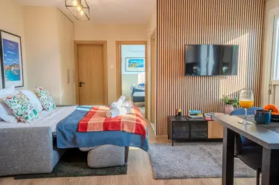 a bedroom with a bed and a flat screen tv at New Central 2 bedroom Apartment in Limassol