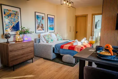 a living room with a bed and a table at New Central 2 bedroom Apartment in Limassol