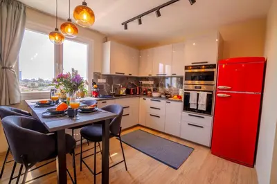 a kitchen with a red refrigerator and a table at New Central 2 bedroom Apartment in Limassol