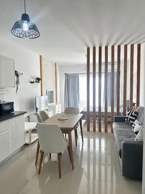 a living room with a table and a couch at Long Beach İskele - Caesar Resort Studio , Near Famagusta in Paralimni