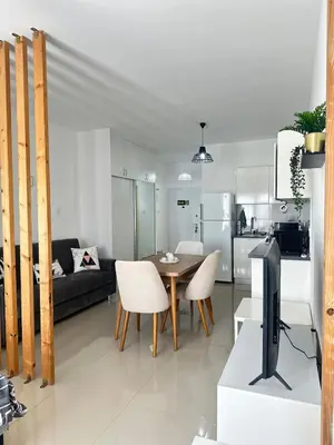 a kitchen and a living room with a table and a tv at Long Beach İskele - Caesar Resort Studio , Near Famagusta in Paralimni