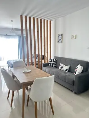 a living room with a table and a couch at Long Beach İskele - Caesar Resort Studio , Near Famagusta in Paralimni