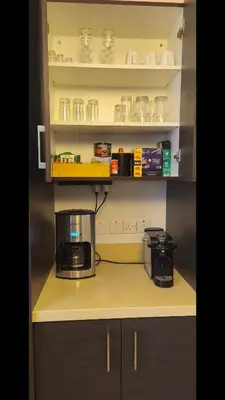a kitchen with a microwave and a coffee maker on a counter at Harmonia Home in Paralimni