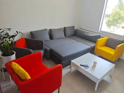 a living room with a couch and two chairs and a table at Harmonia Home in Paralimni
