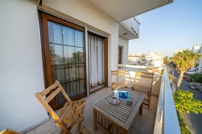 a balcony with a table and chairs on a balcony at 3 bedroom flat central, beach, walking streets in Limassol