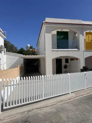 a white picket fence in front of a house at Luxury Beach Villa 2 min Walk to Sea & Airport in Meneou