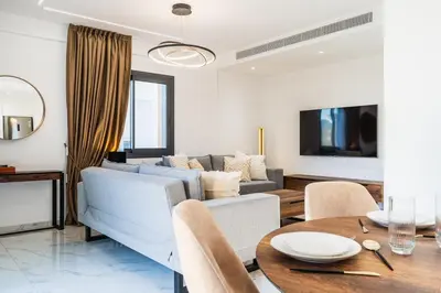 a living room with a couch and a table at Casino & Mall Luxury Jacuzzi Penthouse Suite in Limassol