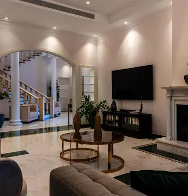 a living room with a fireplace and a tv at Cyprus Sunbay Retreat in Ayia Napa