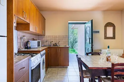 a kitchen with a table and a dining room at Mountain Retreat in Kyperounda