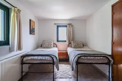 a room with two twin beds and a window at Mountain Retreat in Kyperounda