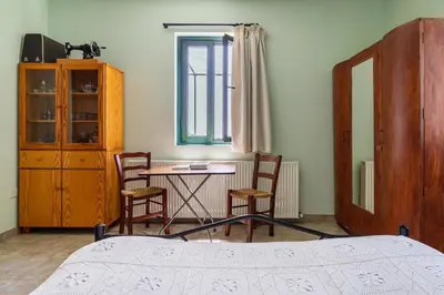 a bedroom with a bed and a table and chairs at Mountain Retreat in Kyperounda