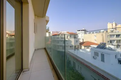 a balcony with a view of some buildings at Downtown City View 2 Bedroom Apartment in Larnaka