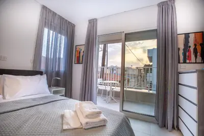 a bedroom with a bed with two towels on it at Two Bedroom House In Town Center by Sweet Keys in Limassol