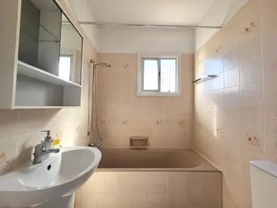 a bathroom with a sink and a bath tub at City Heart Residence by Staycom in Nicosia