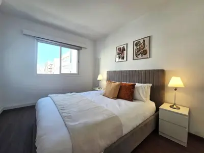a bedroom with a large bed and a window at City Heart Residence by Staycom in Nicosia