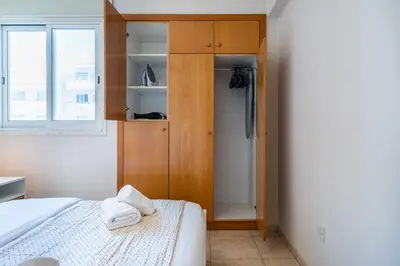 a bedroom with a bed and a closet at Calina - 3BR Apt W Pool & Balcony in Mackenzie in Larnaka