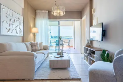 a living room with a couch and a table at Calina - 3BR Apt W Pool & Balcony in Mackenzie in Larnaka