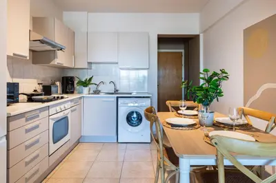 a kitchen with a table and a dining room at Calina - 3BR Apt W Pool & Balcony in Mackenzie in Larnaka