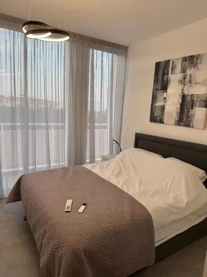 a bedroom with a bed with two cards on it at Modern Marvel Seaview in Paralimni