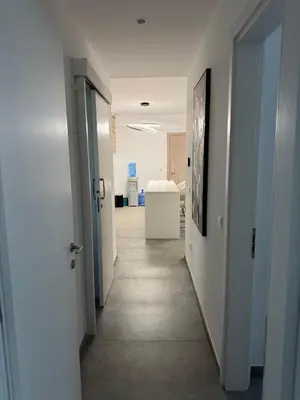 an office hallway with white walls and a hallway with doors at Modern Marvel Seaview in Paralimni