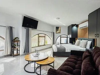 a living room with a couch and a bed at Super Views Larnaca in Larnaka