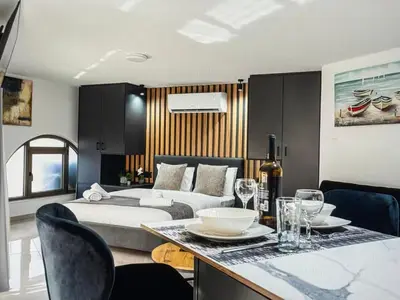 a bedroom with a bed and a table with wine glasses at Super Views Larnaca in Larnaka