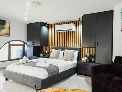 a bedroom with a large bed and a couch at Super Views Larnaca in Larnaka