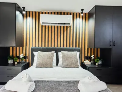 a bedroom with a large bed with two white pillows at Super Views Larnaca in Larnaka
