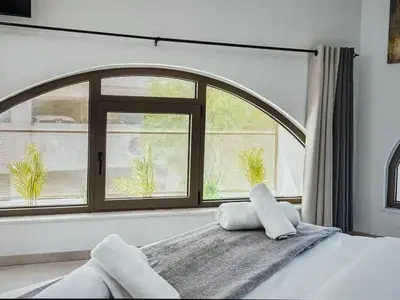 a bedroom with a large window and a bed at Super Views Larnaca in Larnaka