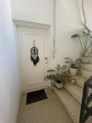a white door with an image of an umbrella on it at Famagusta Guest House in Mağusa