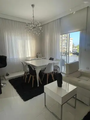 a living room with a white table and a couch at Famagusta Guest House in Mağusa