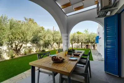 a wooden table and chairs on a patio at Apartment Ino in Protaras