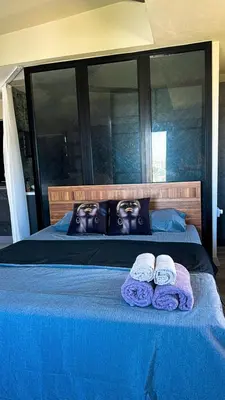 a bed with two towels on top of it at Centrally located studio with Mountain & Sea views in Avdhelleron