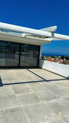 a building with windows on the side of it at Centrally located studio with Mountain & Sea views in Avdhelleron