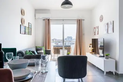 a living room with a table and chairs at Sonic 2-Bedroom Apartment in Larnaka