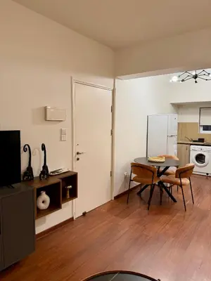 a living room with a table and a dining room at Relax Beach Apartment in Larnaka