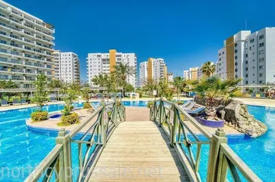 a bridge over a swimming pool in a city at Апартаменты Студия in Dherinia